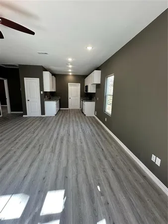 a view of a kitchen with wooden floor