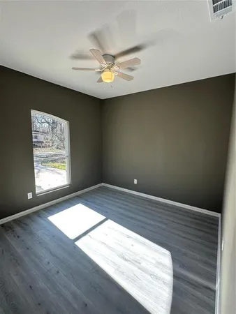 wooden floor in an empty room with a window