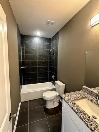 a bathroom with a toilet a sink and shower