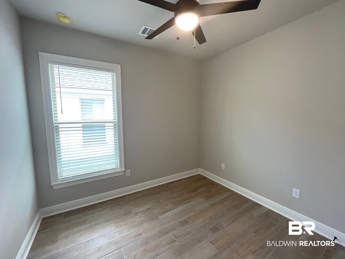 1412 Fenton Circle Foley, AL 36535 - Photo 7 of 15 Empty room with ceiling fan and wood-type flooring