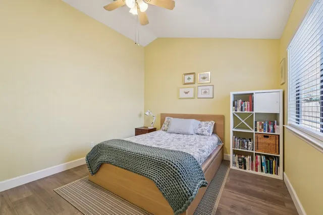 a bedroom with a bed and a bookshelf