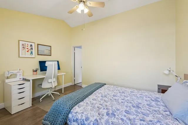 a bedroom with a bed and a desk