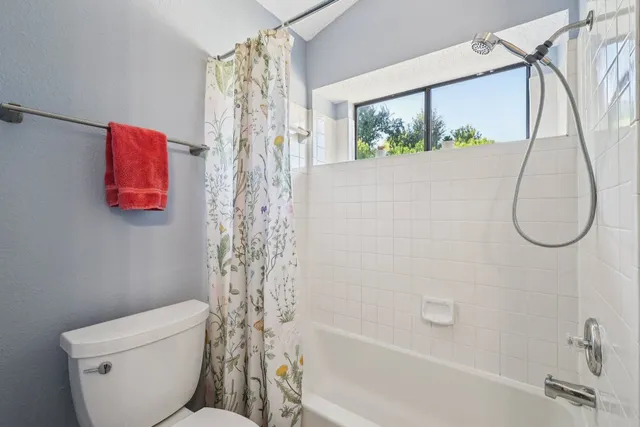 a bathroom with a toilet and shower