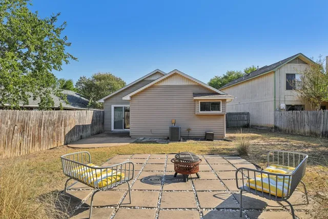 a view of a house with backyard and sitting area