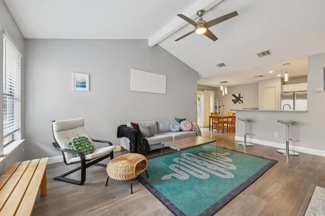 a living room with furniture and wooden floor