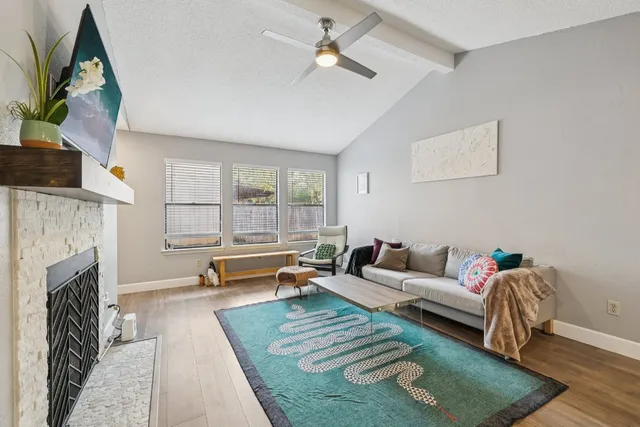 a living room with furniture and a fireplace