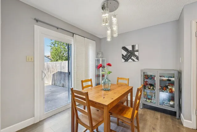 a view of a dining room with furniture wooden floor and chandelier