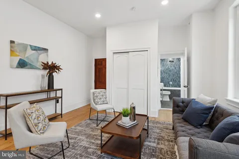 a living room with furniture and wooden floor