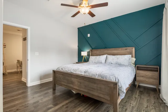 a bedroom with a bed and a chandelier
