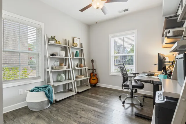 a view of a livingroom with workspace and a window