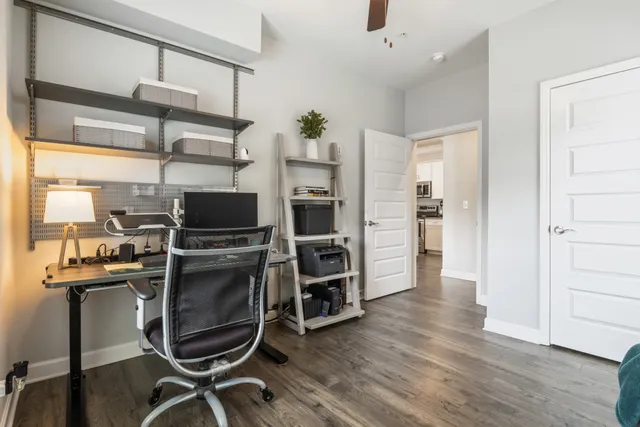 a view of a kitchen with wooden floor and electronic appliances