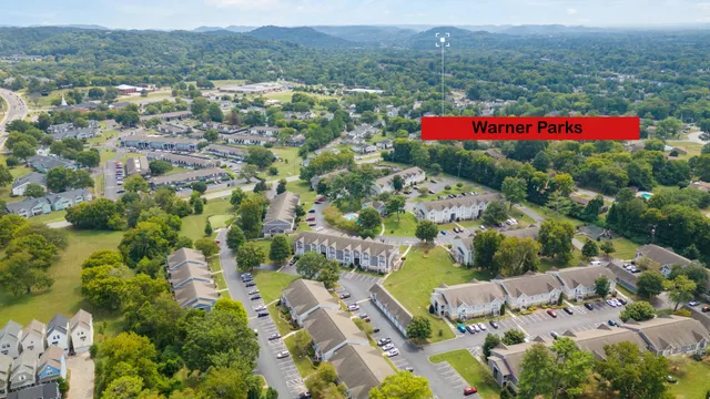 an aerial view of residential houses with outdoor space and street view