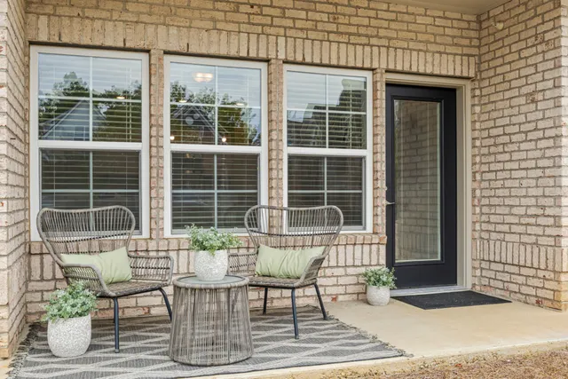 a view of a house that has a table and chair