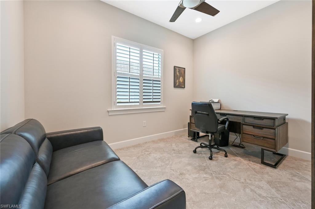 4909 Andros Drive Naples, FL 34113 - Photo 11 of 33 a view of a workspace with furniture and a window