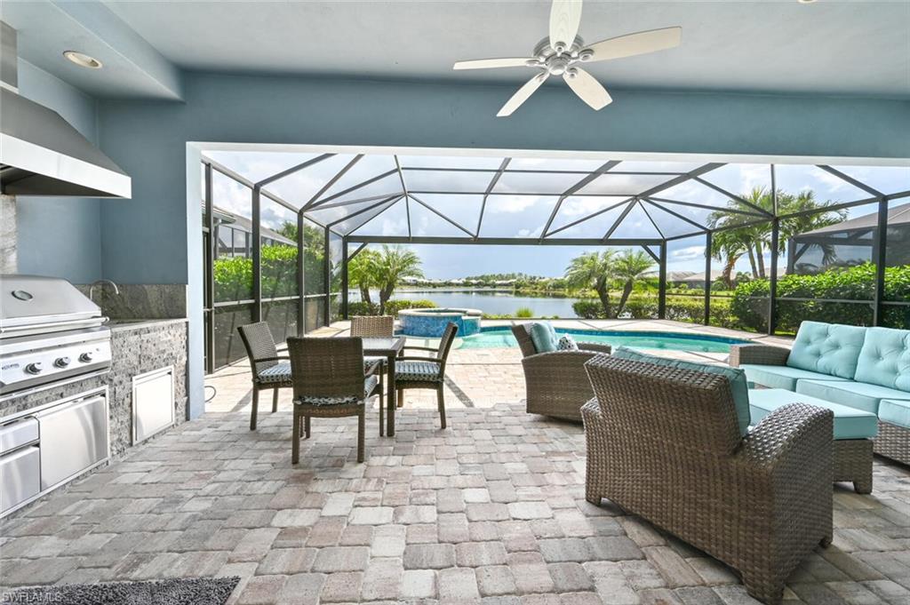 4909 Andros Drive Naples, FL 34113 - Photo 18 of 33 a dining room with furniture a garden and patio