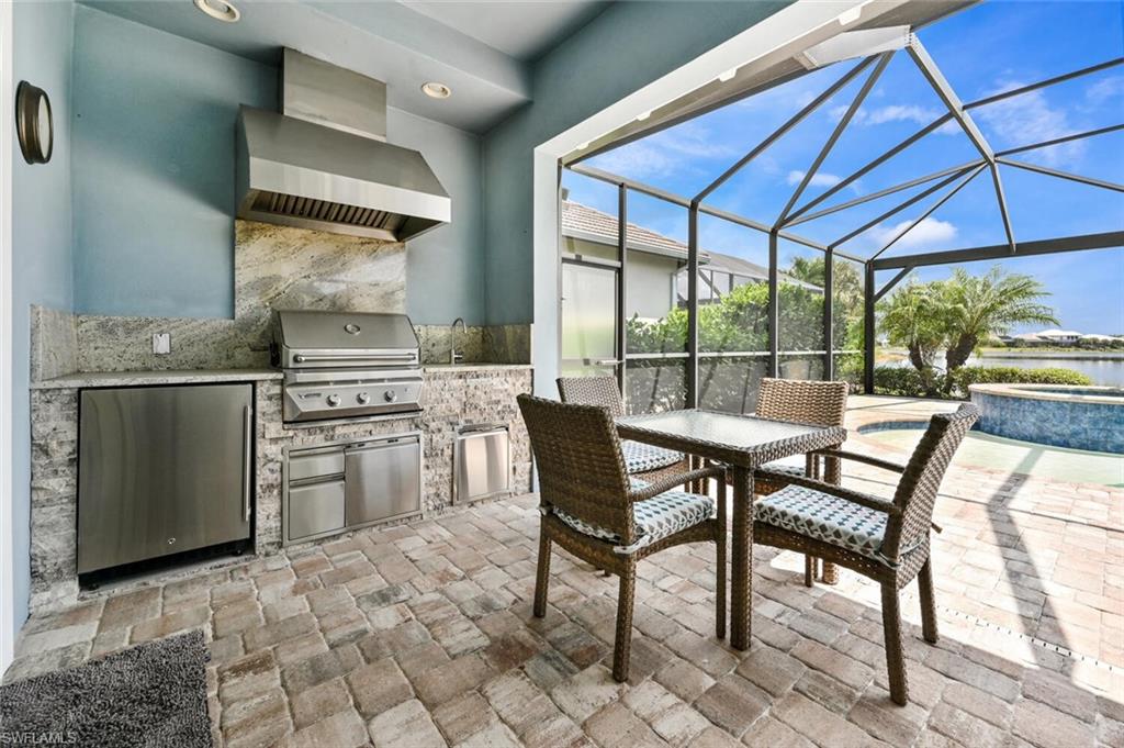 4909 Andros Drive Naples, FL 34113 - Photo 19 of 33 a table and chairs in a kitchen