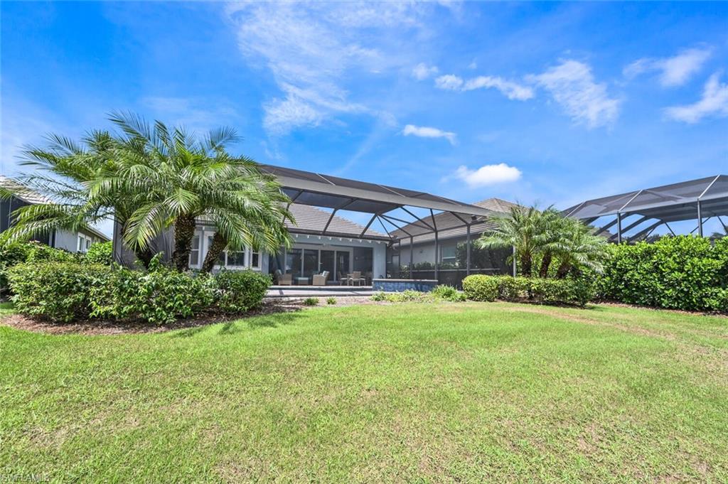 4909 Andros Drive Naples, FL 34113 - Photo 20 of 33 a view of a house with a yard and sitting area