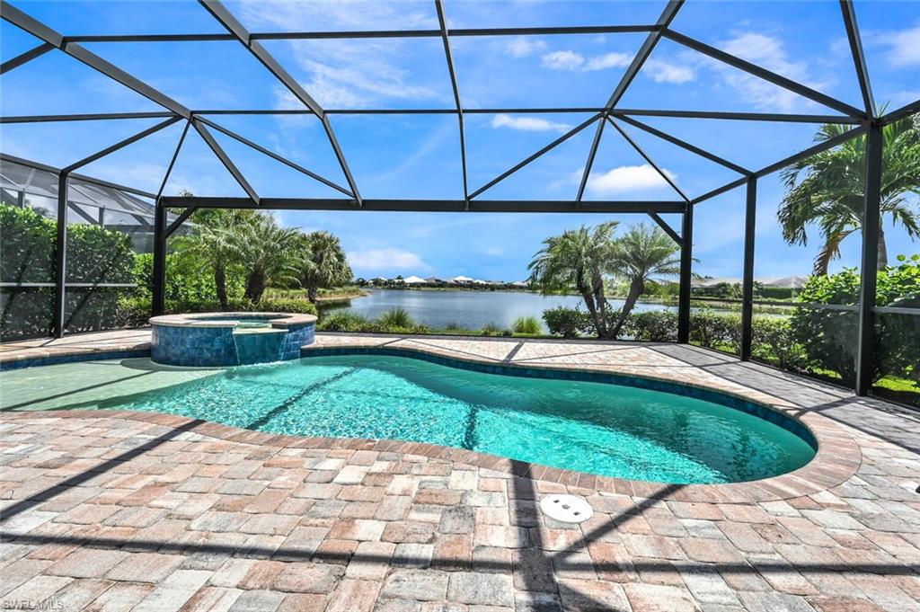 4909 Andros Drive Naples, FL 34113 - Photo 22 of 33 a view of a backyard with a patio and garden