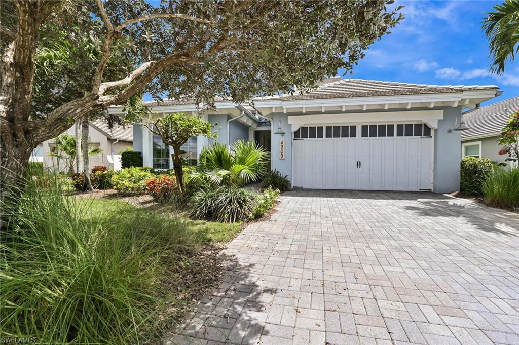 4909 Andros Drive Naples, FL 34113 - Photo 24 of 33 a front view of house with yard and green space