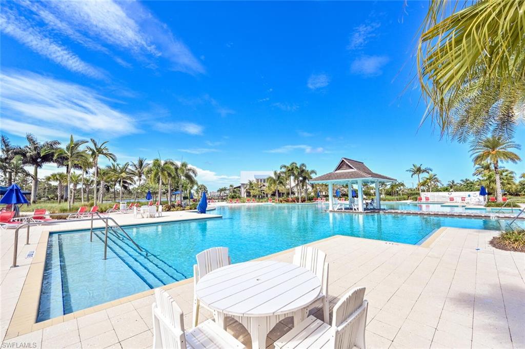 4909 Andros Drive Naples, FL 34113 - Photo 26 of 33 a view of a lake from a terrace