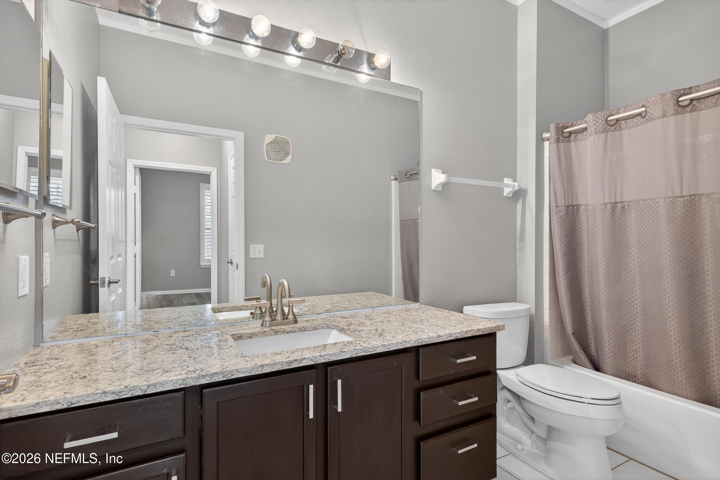 10550 Baymeadows Road, Unit 912 Jacksonville, FL 32256 - Photo 13 of 21 a bathroom with a granite countertop sink toilet and shower