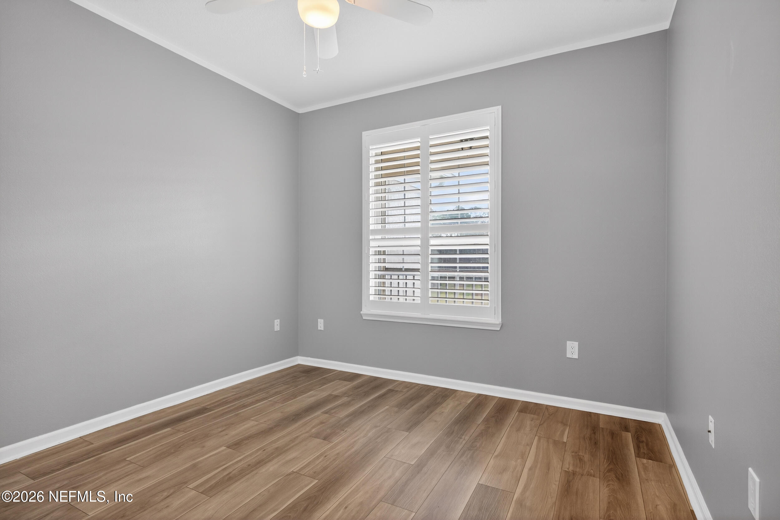 10550 Baymeadows Road, Unit 912 Jacksonville, FL 32256 - Photo 14 of 21 an empty room with wooden floor and windows