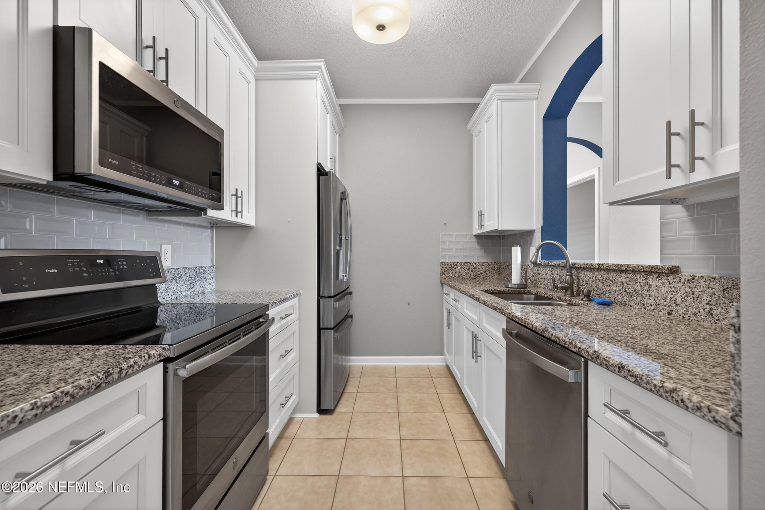 10550 Baymeadows Road, Unit 912 Jacksonville, FL 32256 - Photo 5 of 21 a kitchen with stainless steel appliances granite countertop a sink stove and microwave