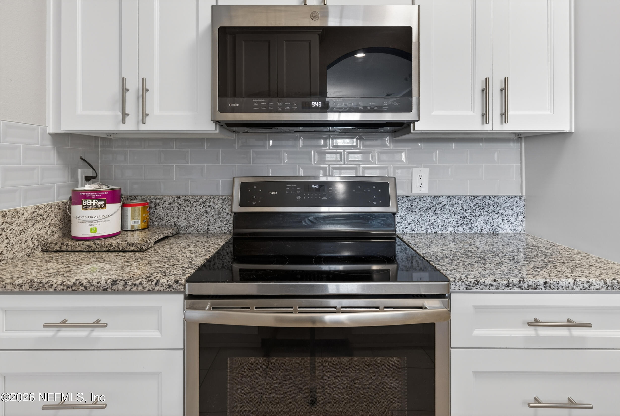 10550 Baymeadows Road, Unit 912 Jacksonville, FL 32256 - Photo 7 of 21 a kitchen with granite countertop white cabinets and stainless steel appliances