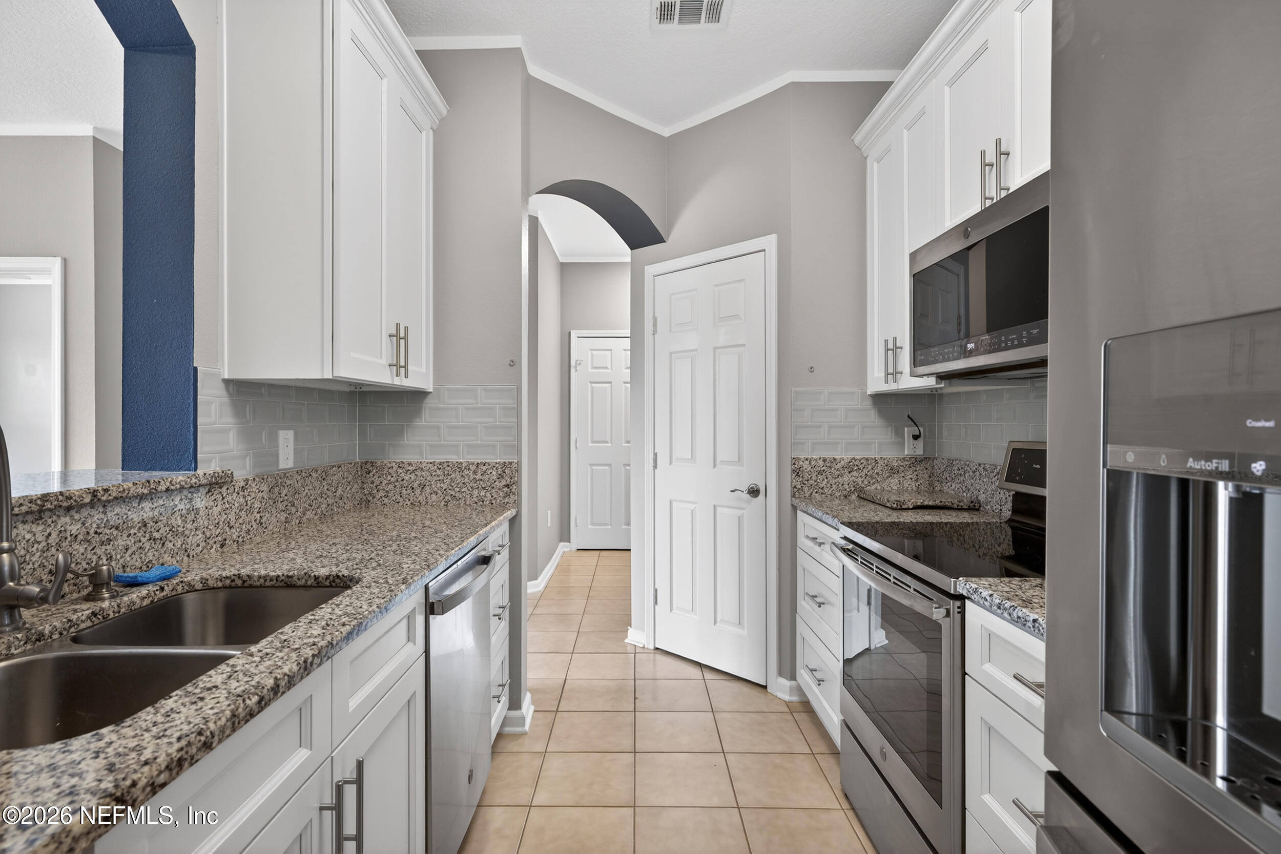 10550 Baymeadows Road, Unit 912 Jacksonville, FL 32256 - Photo 9 of 21 a kitchen with stainless steel appliances granite countertop a sink stove and refrigerator