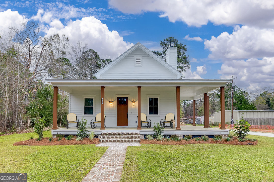 a view of a house with a backyard porch and sitting area