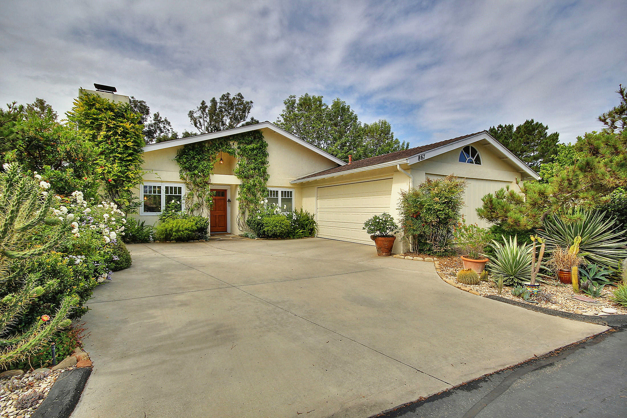 867 Via Abajo Santa Barbara, CA 93110 - Photo 1 of 26 a view of a house with a yard and plant