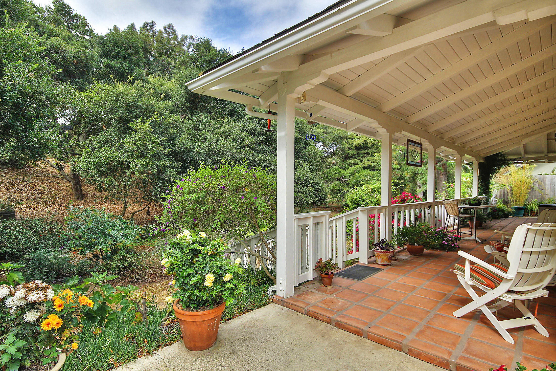 867 Via Abajo Santa Barbara, CA 93110 - Photo 11 of 26 a view of a patio with table and chairs potted plants with wooden floor and seating space