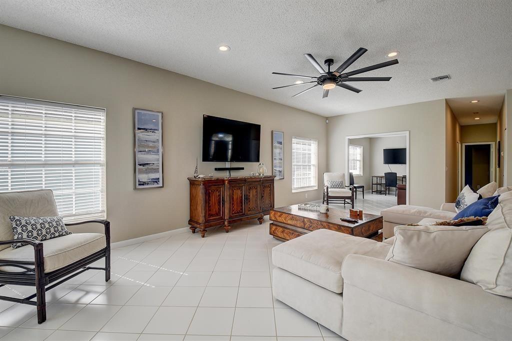 7769 Mansfield Hollow Road Delray Beach, FL 33446 - Photo 9 of 18 a living room with furniture and a flat screen tv