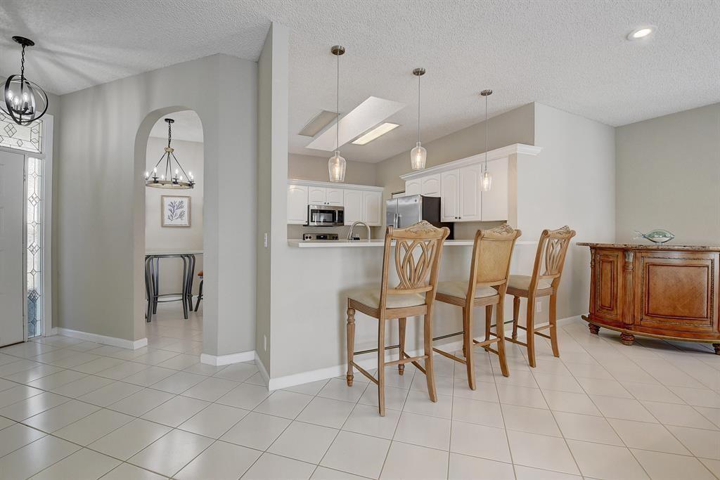 7769 Mansfield Hollow Road Delray Beach, FL 33446 - Photo 10 of 18 a view of kitchen and dining area with a sink