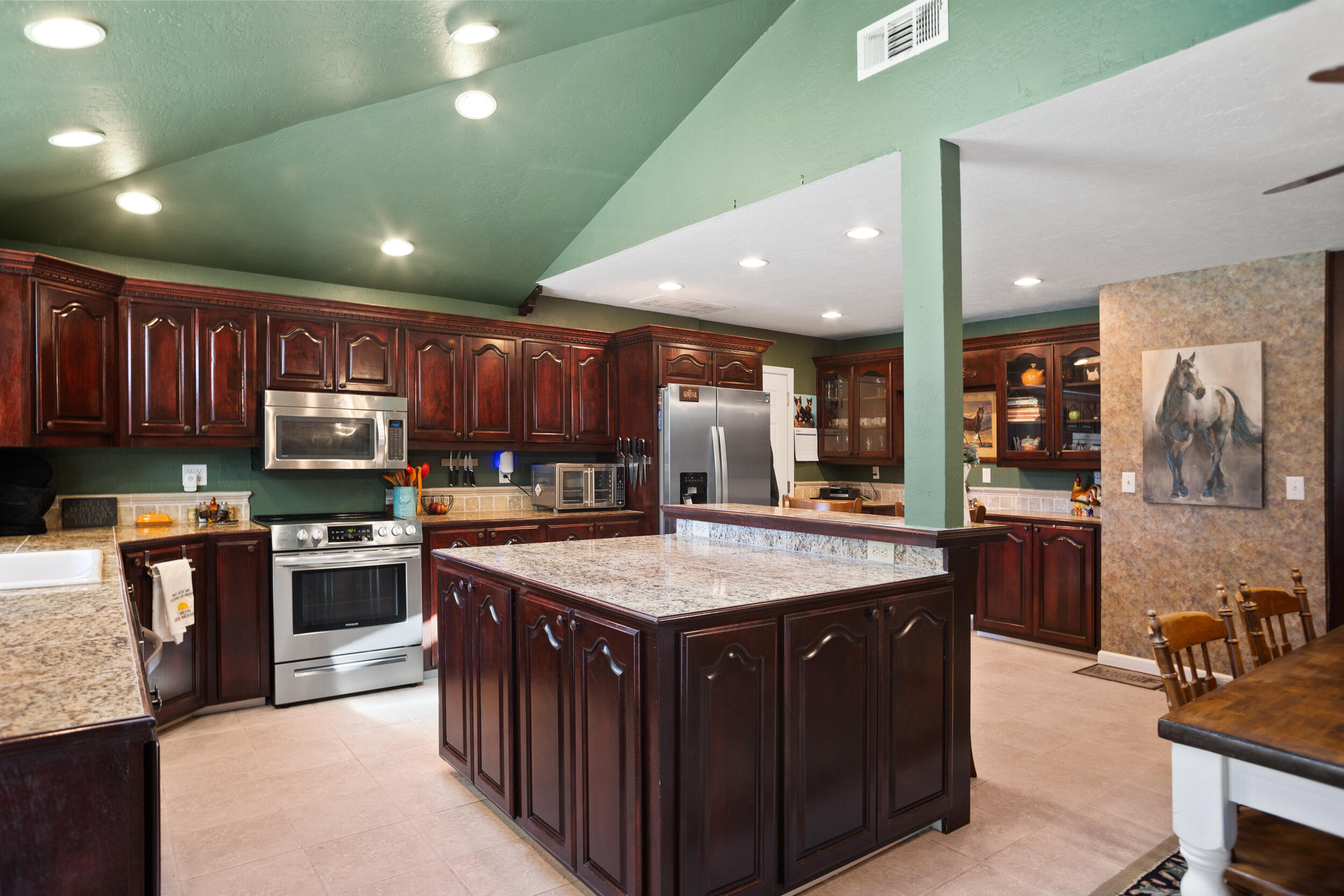 255 Queens Branch Road Rogue River, OR 97537 - Photo 10 of 60 a kitchen with stainless steel appliances granite countertop wooden cabinets a sink and a stove