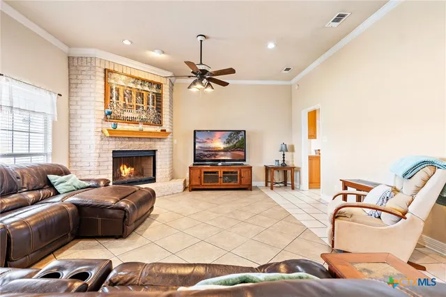 a living room with furniture a fireplace and a flat screen tv
