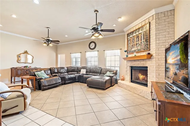 a dining hall with stainless steel appliances kitchen island granite countertop a dining table chairs and view living room