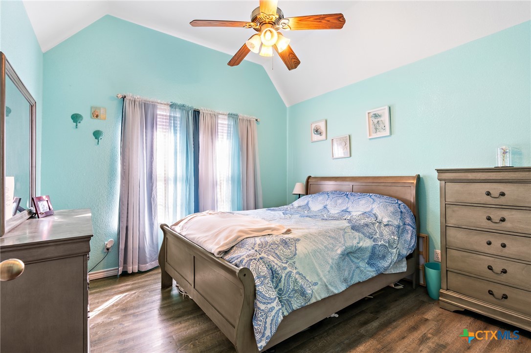 155 Western Ridge Road Gatesville, TX 76528 - Photo 20 of 26 a bedroom with a bed and a chandelier