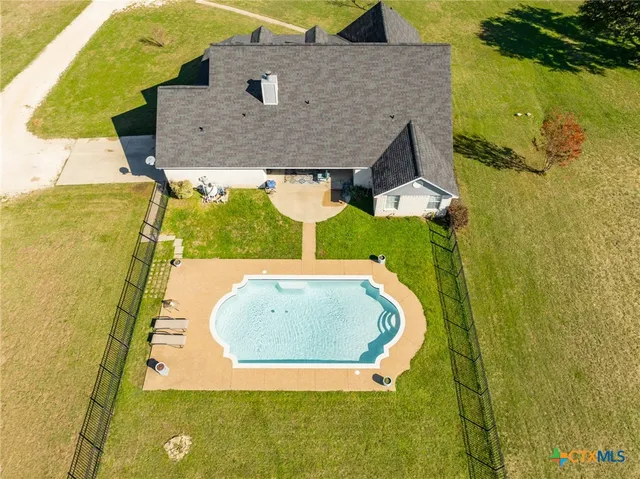 an aerial view of house with a swimming pool