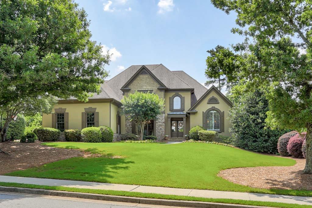 a front view of a house with a garden