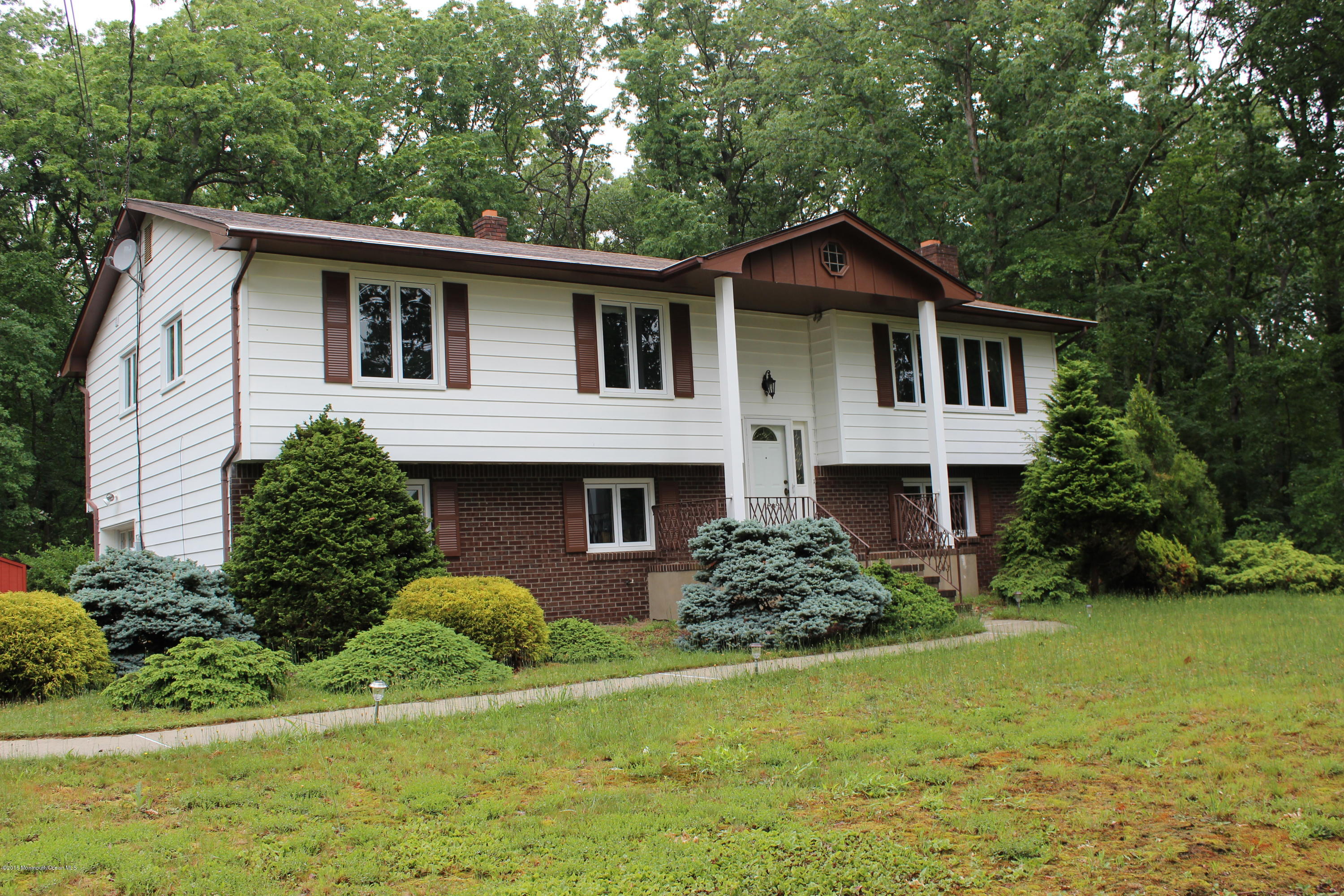3 Sunnyside Road Howell, NJ 07731 - Photo 2 of 28 a front view of a house with a yard and garage