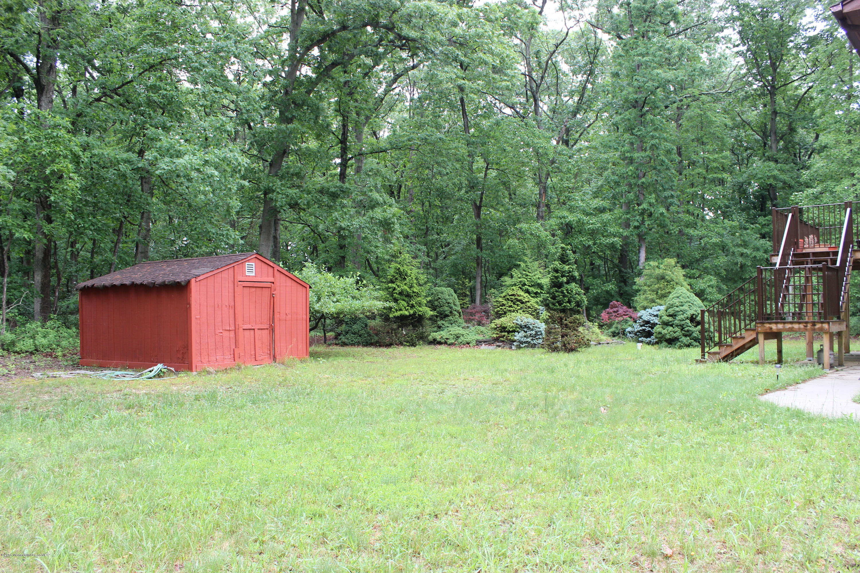 3 Sunnyside Road Howell, NJ 07731 - Photo 28 of 28 a view of a backyard with potted plants and large trees