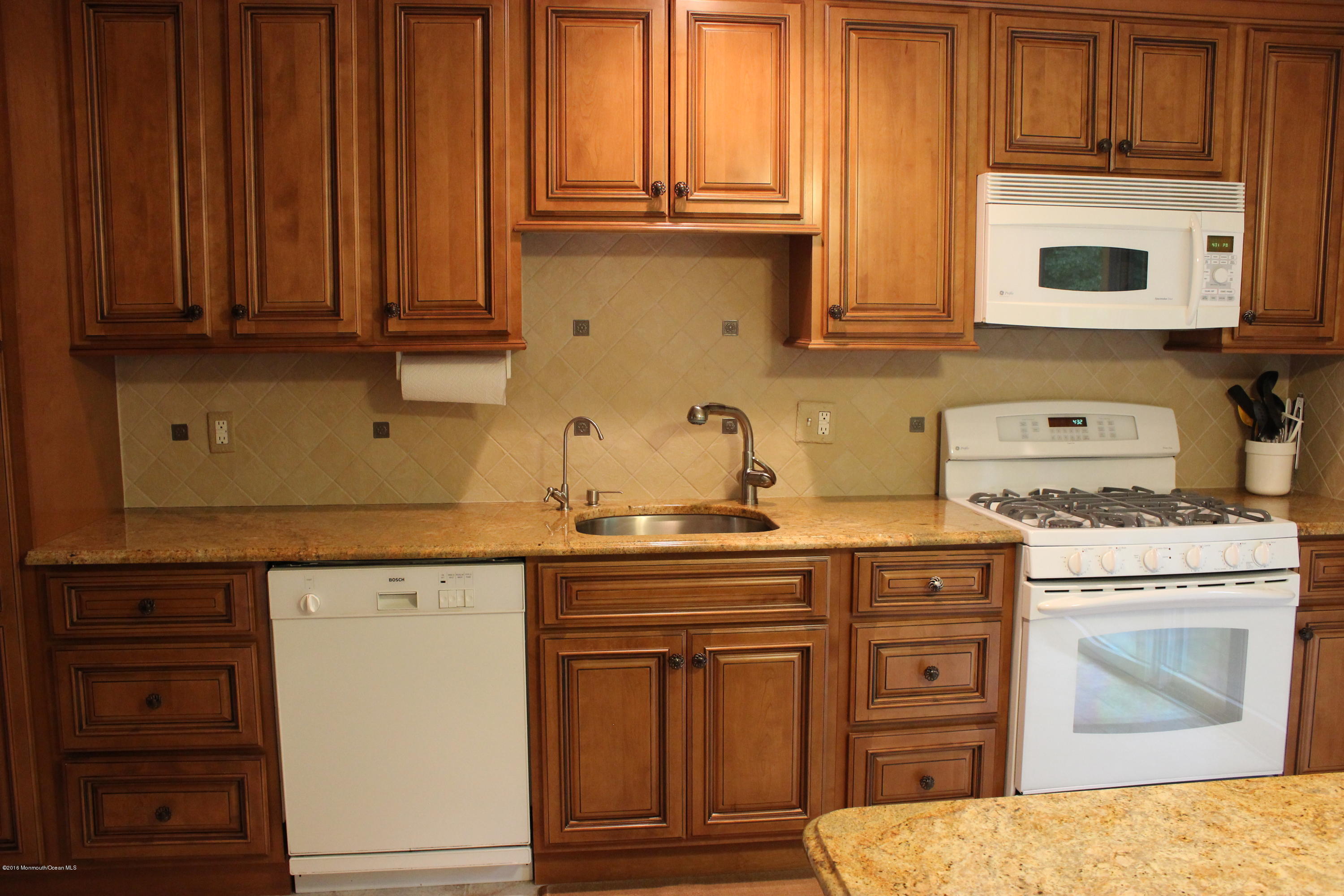 3 Sunnyside Road Howell, NJ 07731 - Photo 3 of 28 a kitchen with stainless steel appliances granite countertop a stove a microwave oven cabinets and a wooden floor