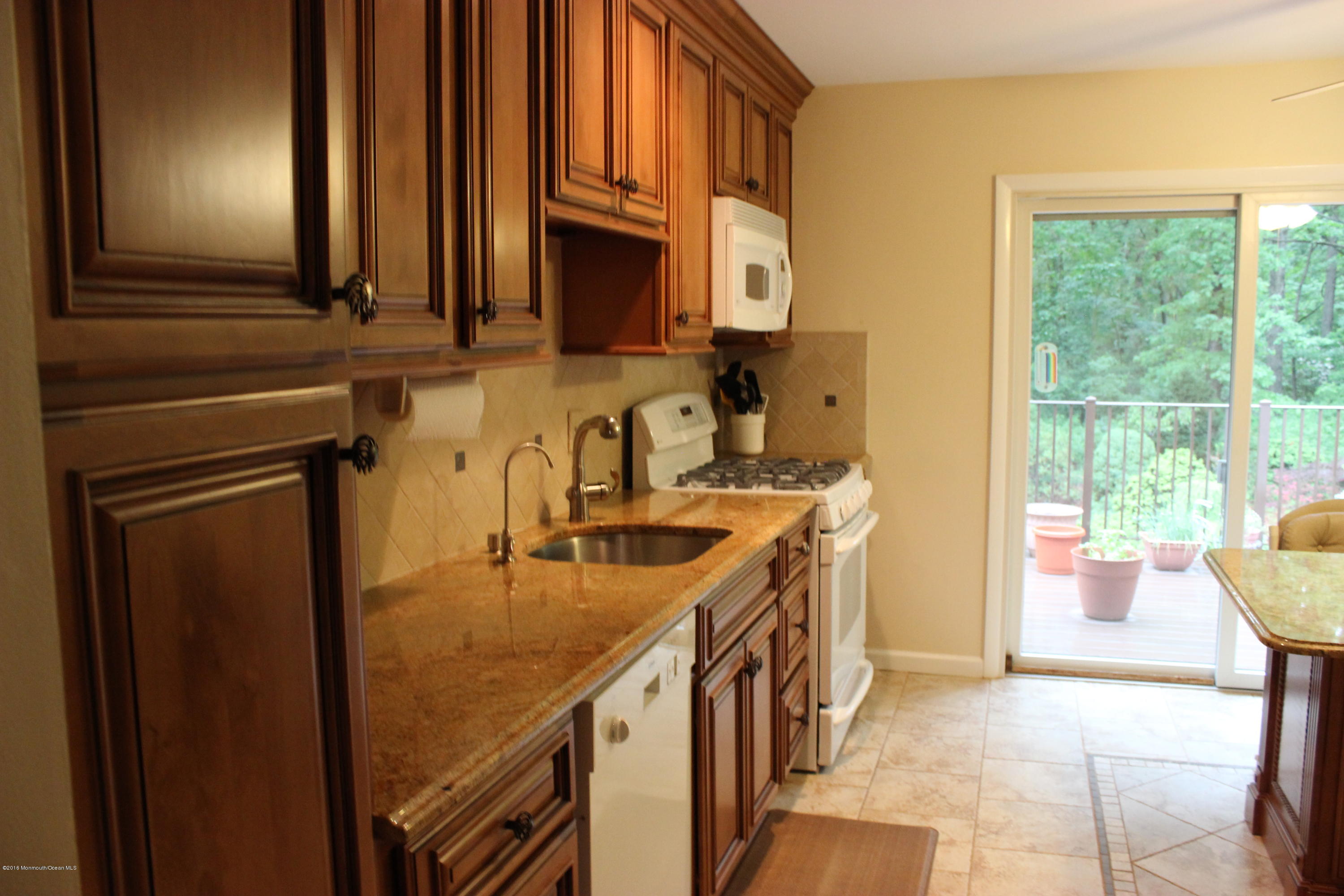 3 Sunnyside Road Howell, NJ 07731 - Photo 5 of 28 a kitchen with stainless steel appliances granite countertop a sink and a cabinets
