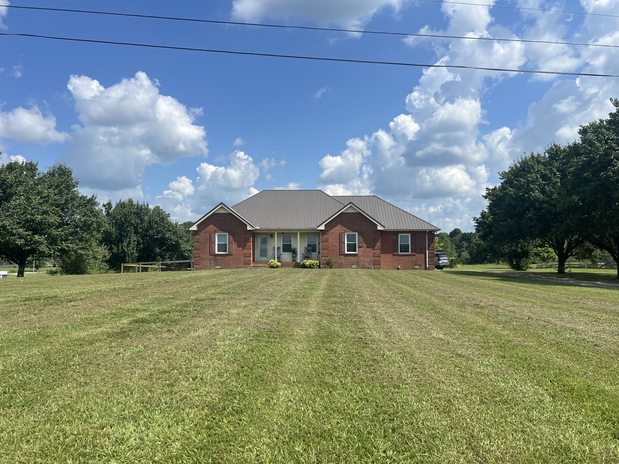 578 Cook Road Portland, TN 37148 - Photo 3 of 27 a view of a big house with a big yard and large trees