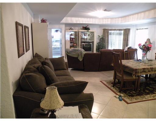 4625 Southwest Inagua Street Port St. Lucie, FL 34953 - Photo 2 of 9 a living room with furniture and wooden floor