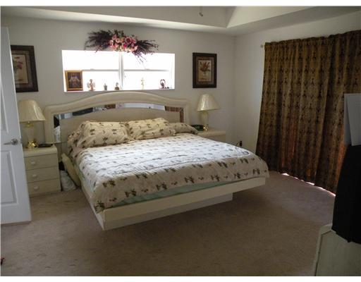 4625 Southwest Inagua Street Port St. Lucie, FL 34953 - Photo 4 of 9 a bedroom with a bed and a window