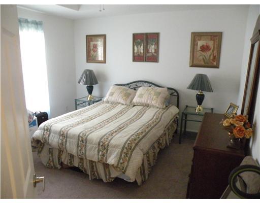 4625 Southwest Inagua Street Port St. Lucie, FL 34953 - Photo 8 of 9 a bedroom with a bed and a painting on the wall