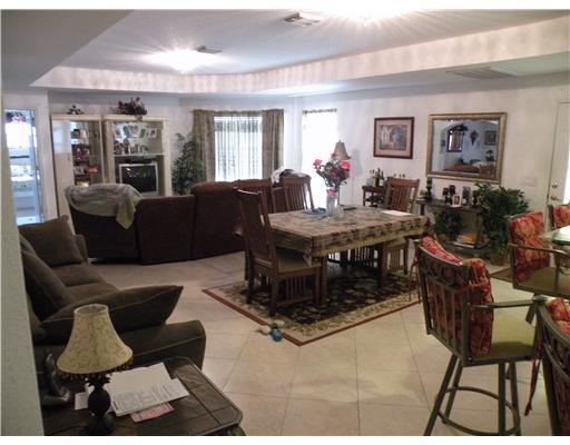 4625 Southwest Inagua Street Port St. Lucie, FL 34953 - Photo 9 of 9 a living room with furniture and wooden floor