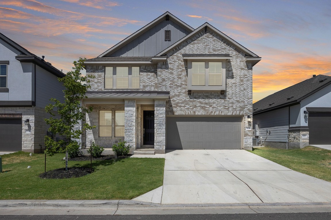 a front view of a house with a garden and plants